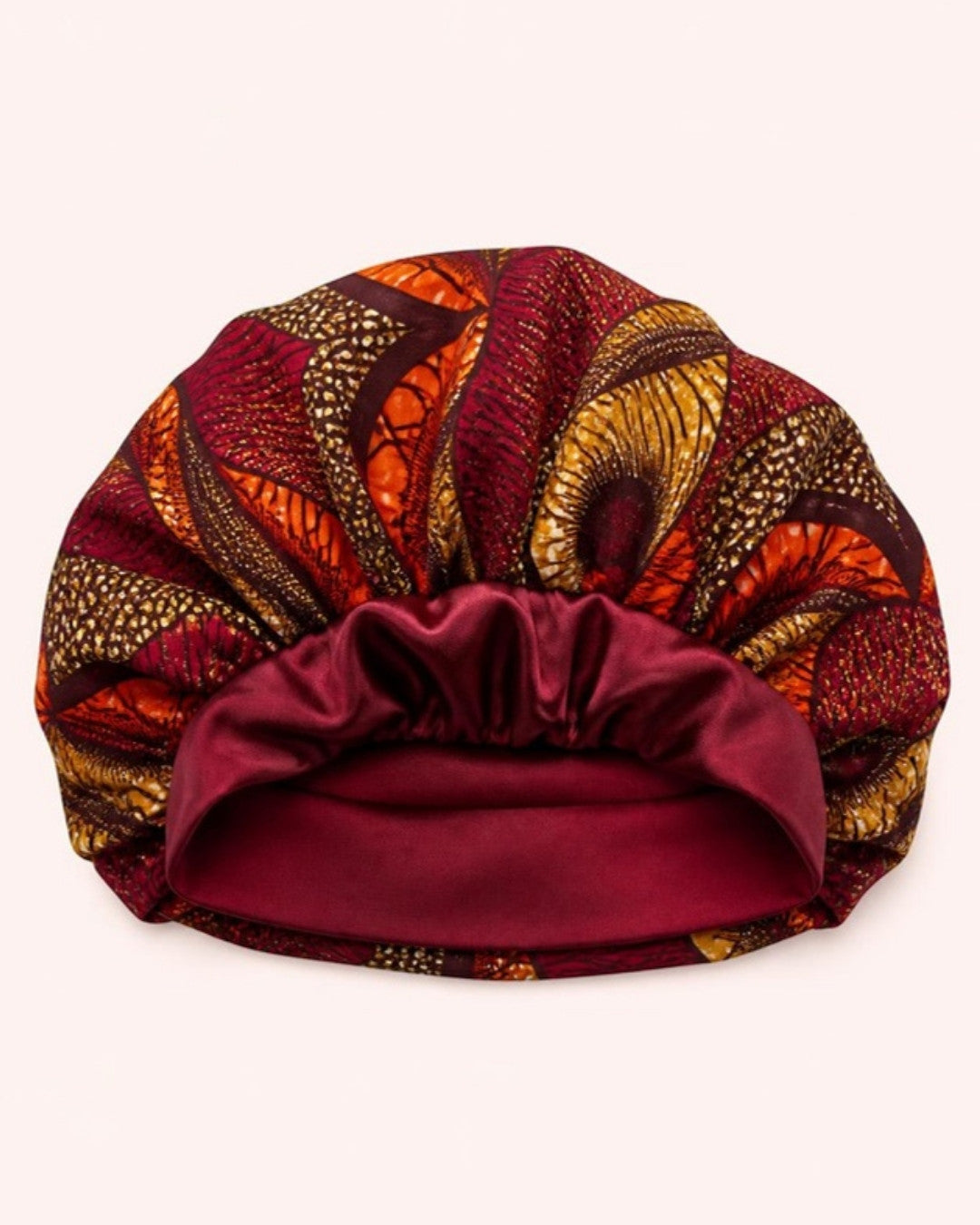 Reversible bonnet with wax print outside and burgundy satin inside